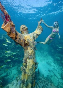 Snorkeler Katherine Wieland examines the Christ of the Abyss statue in the Florida Keys National Marine Sanctuary off Key Largo, Fla. This nine-foot-tall, 4,000 pound replica of a similar statue, located in the waters off the coast of Italy, is submerged in 25 feet of water at Key Largo Dry Rocks. Photo by Stephen Frink/Florida Keys News Bureau